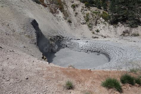 A Thermal Muddy Pond And Cave At Yellowstone Park Stock Photo Image