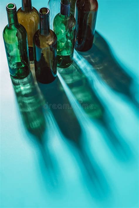 Empty Alcohol Bottles Hard Light Glass Shadows On A Blue Background Top View Space For Text