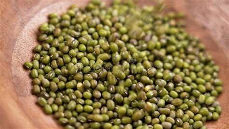 Green Mung Beans Falling Into A Wooden Bowl Product Of Ecological