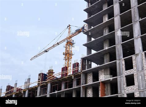 High Rise Building Under Construction And Crane Against The Sky Stock