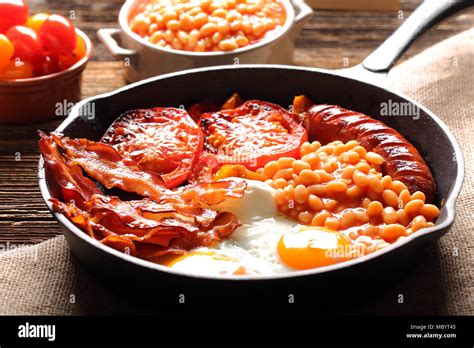 English Breakfast With Sausages Grilled Tomatoes Egg Bacon And Beans