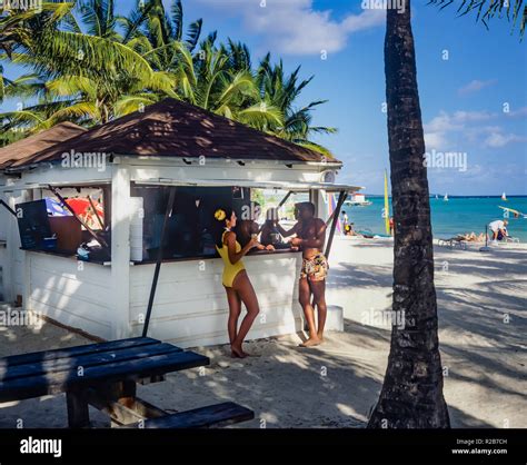 People chatting at beach bar, tropical beach, palm trees, Caribbean sea ...