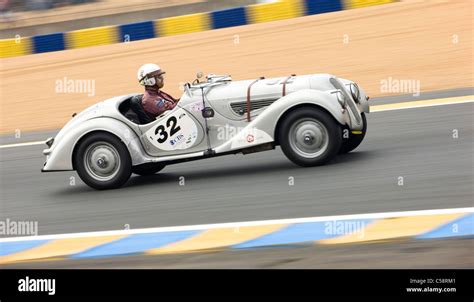 An Old Classic Car Races Round The Track Le Mans Classic Car Race