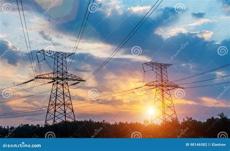 High Voltage Power Transmission Towers In Sunset Sky Background Stock