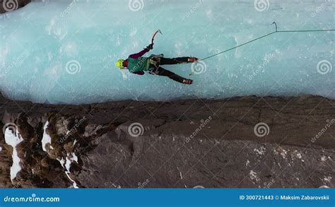 Woman Is Leading On Ice Ice Climbing On Frozen Waterfall Aerial View