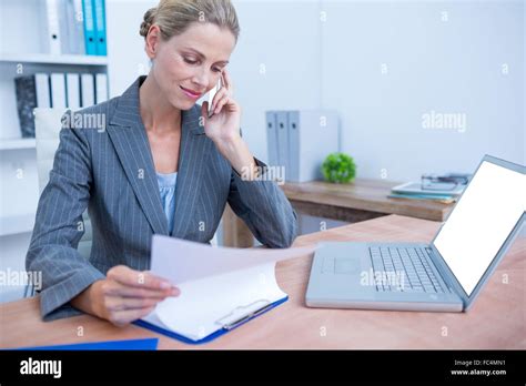 Pretty Blonde Businesswoman Phoning And Using Her Laptop Stock Photo Alamy