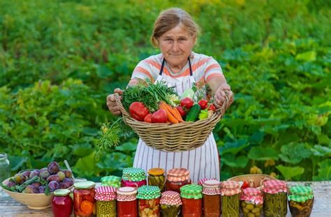 Premium Photo Senior Woman Preserving Vegetables In Jars Selective Focus