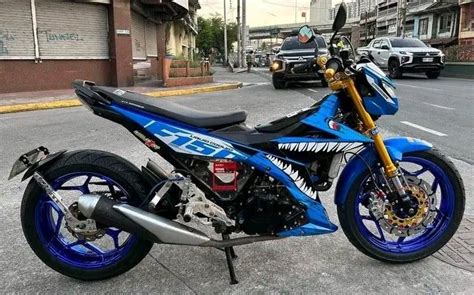 a blue and black motorcycle parked on the street