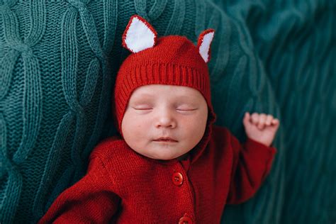 Adorable Newborn Baby Resting On Soft Blue Plaid In Studio · Free Stock