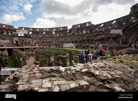 Tourists Walking Among The Ruins Of The Roman Colosseum Rome Italy