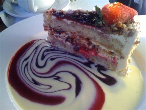 A Piece Of Cake Sitting On Top Of A White Plate Covered In Chocolate