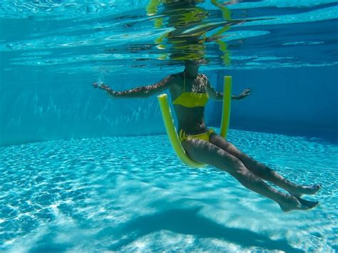 Premium Photo Underwater View Of Woman Sitting On Swimming Noodle