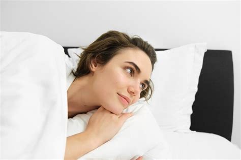 Free Photo Close Up Portrait Of Beautiful Brunette Woman Waking Up In Her Bed Looking At Alarm