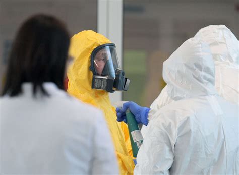 Putin dons hazmat suit, as Russia admits virus numbers likely far ...