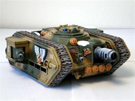 A Small Toy Tank Sitting On Top Of A Table