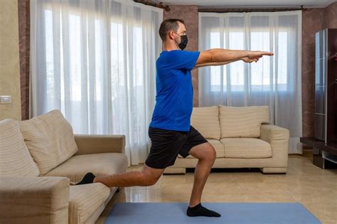 Premium Photo Man Wearing Flu Mask Exercising At Home