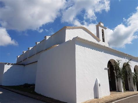 A White Building With A Cross On The Top