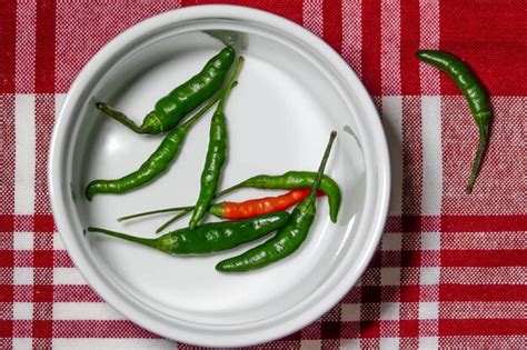 Premium Photo Chili Peppers Inside Bowl On Red Table Cloth