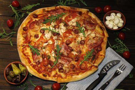 Pizza With Bacon Sausages Ham Tomato And Olives Sprinkle With