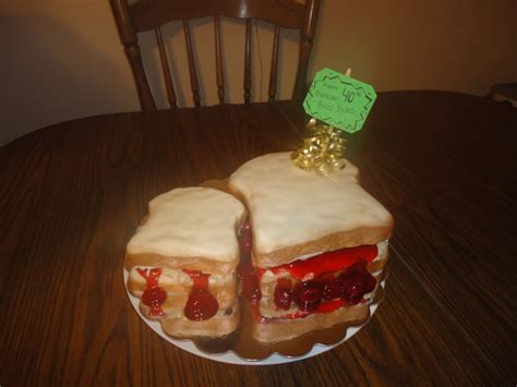 Two Sandwiches On A Plate Sitting On A Table With A Note Attached To