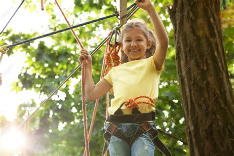 Little Girl Climbing In Adventure Park Summer Camp Stock Photo