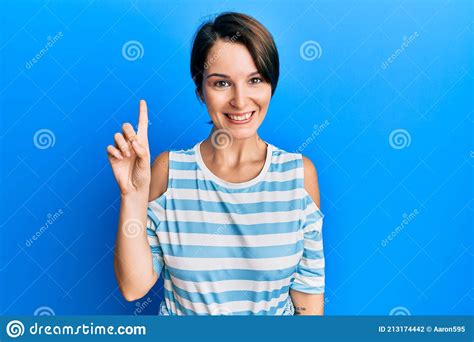 Young Brunette Woman With Short Hair Wearing Casual Striped T Shirt