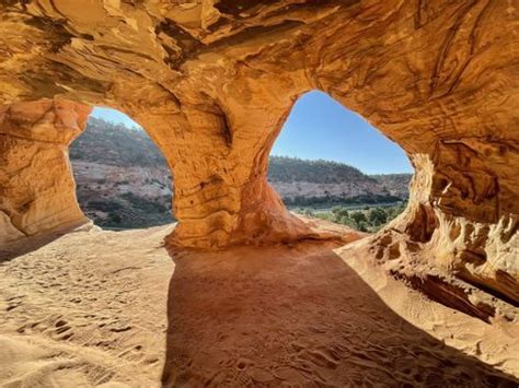 The Inside Of A Rock Formation With Sand And Rocks