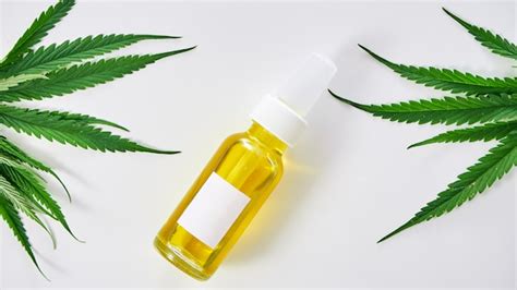 Premium Photo | Cannabis with extract oil in a bottle