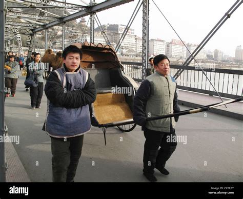 People wearing traditional costume walking on Yellow River Iron Bridge ...