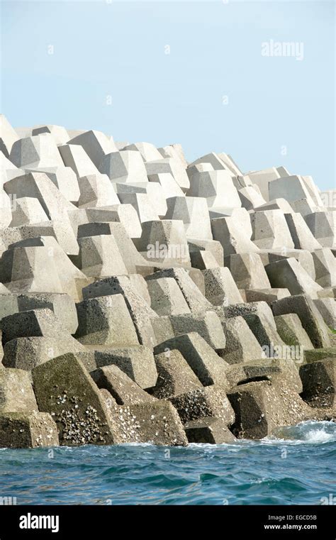 Concrete forms interlocked to make a sea wall breakwater Stock Photo ...