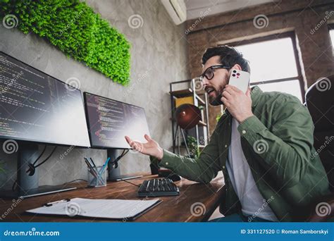portrait  professional hacker young man speak phone computer desk
