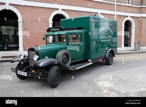 An old fashioned antiques delivery truck on display in the Portsmouth Historic Dockyards, UK ...