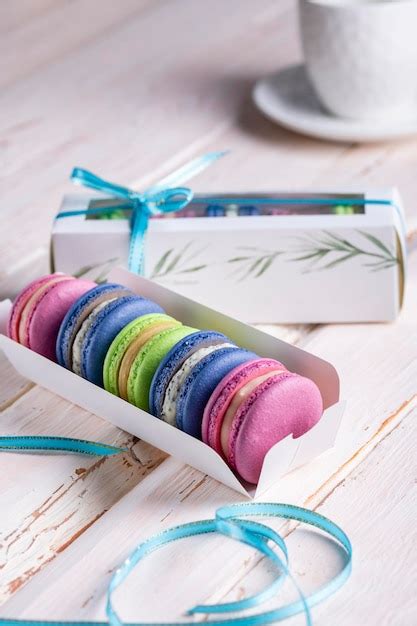 Premium Photo Colorful Macaroons In A Box On A Light Wooden Table Closeup