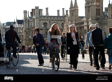 Cambridge University students cycle past Kings College, Cambridge, England. October 2011 Stock ...