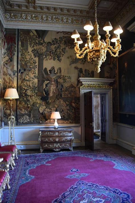 a room with a purple rug and chandelier