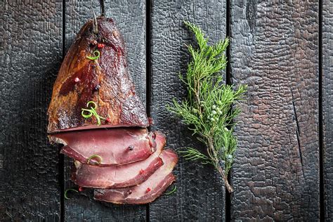 Smoked Ham With A Sprig Of Juniper On A Scorched Tabletop Photograph By