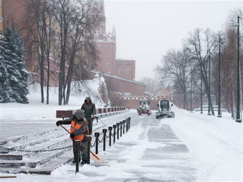 Utility Workers And Tractors Remove Snow From The Kremlin Wall During A