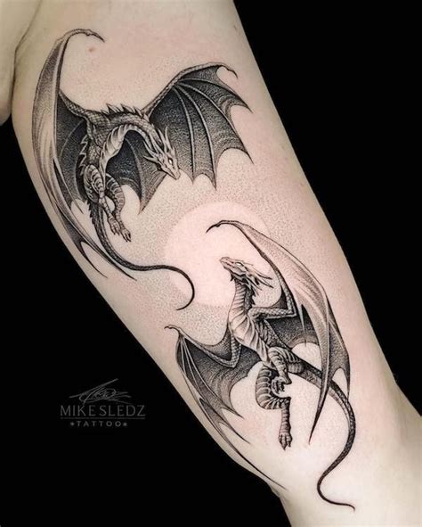 A Black And White Dragon Tattoo On The Arm