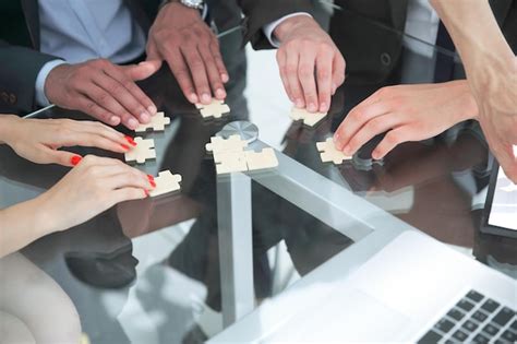 Premium Photo Close Up Multinational Business Team Assembling Puzzle