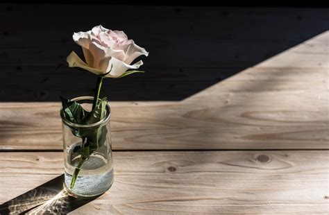 Premium Photo Close Up Of Rose In Glass Vase On Table