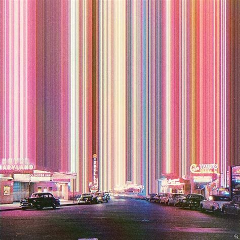 An Image Of Neon Lights In The Sky Over A Street With Cars Parked On It