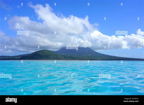 Day view of the Nevis Peak volcano across the water from St Kitts Stock ...