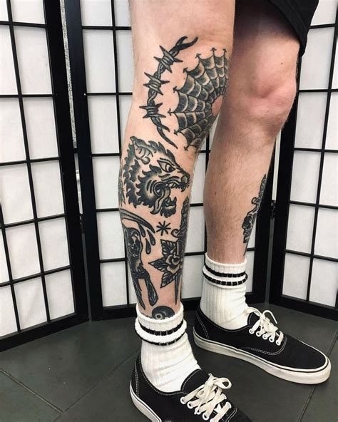 A Man With Black And White Tattoos On His Legs