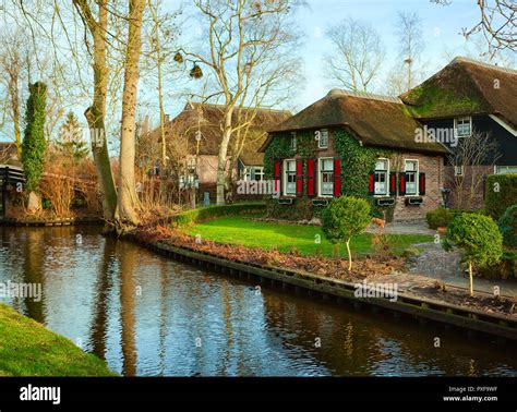 Canal in Giethoorn at sunny winter morning, Netherlands. Giethoorn is a ...