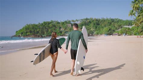 Romantic Surfers Couple In Love Go Out Of Ocean Waves Satisfied With