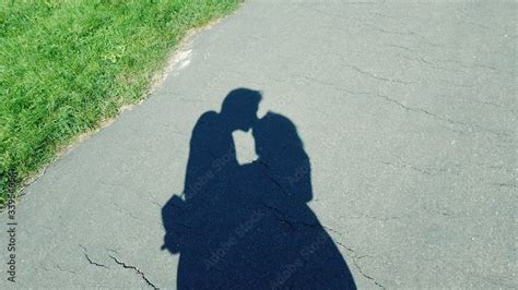 Shadow Of Couple Kissing On Road Stock Photo | Adobe Stock