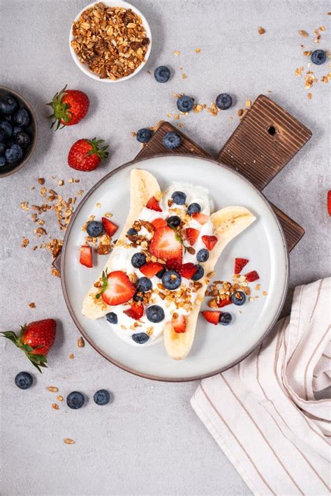 Healthy Banana Split Breakfast With Yogurt Granola And Fresh Berries