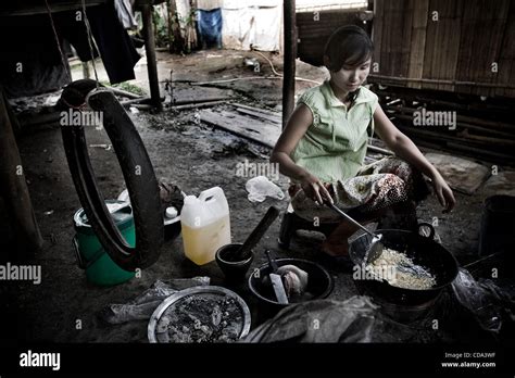 Karen Refugee Woman Cooking Fried Bakery To Sell On The Muddy Ways Onto