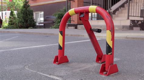 One red parking lock. Close-up video. Reserved car parking space ...