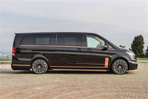 A Black Van Parked On Top Of A Brick Road